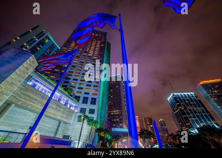 Flaggen und Wolkenkratzer im Zentrum von Miami bei Nacht. Florida, USA Stockfoto