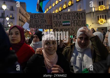 Madrid, Spanien. Dezember 2024. Die Demonstranten halten während einer Kundgebung Plakate. Syrische Einwohner in Madrid haben sich in Puerta del Sol versammelt, um den Fall und das Ende der Regierung von Präsident Baschar al-Assad im arabischen Land zu feiern. Quelle: SOPA Images Limited/Alamy Live News Stockfoto
