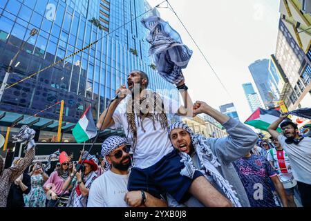 Melbourne, Australien. Dezember 2024. Ein Demonstrant ruft Slogans, während er die palästinensische Flagge hochhebt. Die Demonstranten schwenken palästinensische Flaggen und halten Banner, die ein Ende des Völkermords und der zionistischen Aggression fordern, und rufen in Solidarität für die palästinensische Befreiung und Gerechtigkeit. (Foto: YE Myo Khant/SOPA Images/SIPA USA) Credit: SIPA USA/Alamy Live News Stockfoto