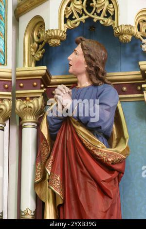 Johannes unter dem Kreuz, Statue auf dem Altar des Heiligen Kreuzes in der Pfarrkirche der Heiligen Dreifaltigkeit in Trojstvo, Kroatien Stockfoto
