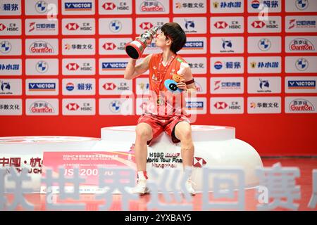 Hangzhou, China. Dezember 2024. Sieger Wang Zhiyi aus China küsst die Trophäe während der Verleihung der Damen-Singles-Veranstaltung bei den BWF World Tour Finals 2024 in Hangzhou, China, 15. Dezember 2024. Quelle: Hou Zhaokang/Xinhua/Alamy Live News Stockfoto