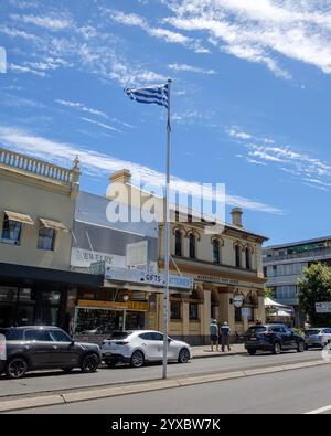 Eine griechische Flagge fliegt auf der Marrickville Road vor dem ehemaligen Postgebäude von Marrickville in Sydney, Australien Stockfoto