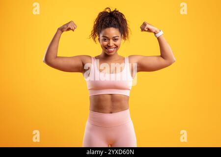 Eine junge Frau steht selbstbewusst mit gebeugten Armen Stockfoto