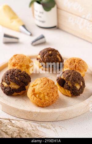 Choux-Gebäck ist ein zarter Teig, der in vielen Backwaren verwendet wird. Es enthält nur Butter, Wasser, Mehl und Eier. Choux-Gebäck wird manchmal gefüllt Stockfoto