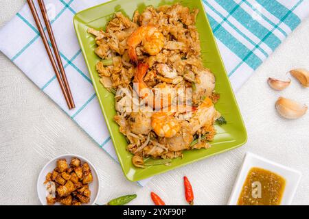 Kwetiau goreng medan oder Saibling kway teow es wird aus Nudeln hergestellt, die in Speiseöl mit Knoblauch, Zwiebeln oder Schalotten, Schweinefleisch, gebratene Garnelen, Stockfoto