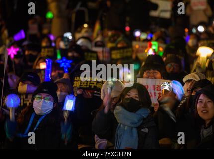 Seoul, Südkorea. Dezember 2024. Demonstranten winken K-POP-Lichtstäbe mit Plakaten mit der Aufschrift 'Verhaften des Aufklärungsbeamten Yoon Suk Yeol!' Während einer Kundgebung, die die Festnahme des angeklagten südkoreanischen Präsidenten Yoon Suk Yeol in der Innenstadt von Seoul forderte. Quelle: SOPA Images Limited/Alamy Live News Stockfoto