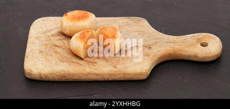 Pastell de yema, kandiertes Eigelb, bedeckt mit Marzipan, einer der vielen spanischen Süßigkeiten, die typisch mit Weihnachten verbunden sind Stockfoto