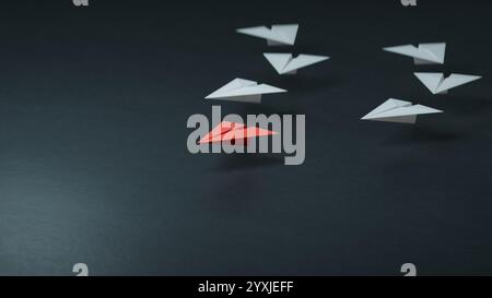 Individualitätskonzept. Ein individuelles und einzigartiges rotes Leader-Papierflugzeug fliegt zur Seite. 3D-Illustration.3D-Rendering auf schwarzem Hintergrund. Stockfoto