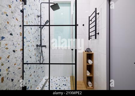 Entdecken Sie ein modernes Duschdesign mit stilvollem Terrazzo und Glas für eine erfrischende Ästhetik Stockfoto
