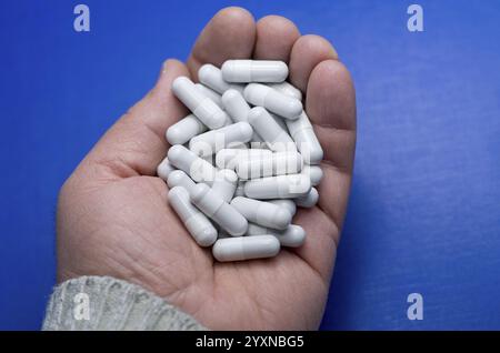 Große weiße Pillen fielen aus einer großen weißen Flasche. Arzneimittelbegriff. Leben ohne Medikamente und Abhängigkeit von Antibiotika-, Medizin-, Amphetamin-Kapseln Stockfoto
