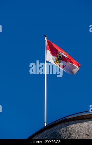 Die österreichische Flagge weht an einem klaren Tag in den Wind, aufgenommen auf der Festung Hohensalzburg Stockfoto
