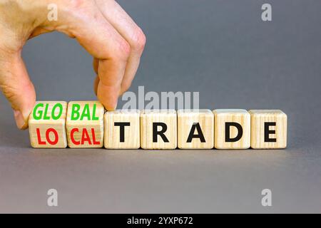 Globales oder lokales Handelssymbol. Concept Words Welthandel lokaler Handel auf schönen Holzblöcken. Schöner grauer Hintergrund. Geschäftsmann Hand. Unternehmen Stockfoto