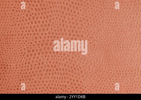 Tuchstruktur aus orangefarbenem Jacquard-Stoff mit abstrakter Shabby-Punktprägung, Textur-Nahaufnahme, Makro. Polsterung, dekorative Stoffstruktur, Heim Stockfoto