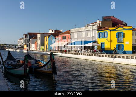 AVEIRO, PORTUGAL - 30. AUGUST 2019: Cais dos Botiroes und die gelbe Casa do Mercado in einem der Kanäle von Aveiro mit den typischen Häusern und moli Stockfoto