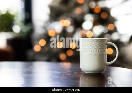Gemütliches Getränk auf Holztisch mit Weihnachtsbaum Hintergrund Stockfoto