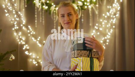 Portrait of a Happy Woman Holding Presents in Her Hands Stockfoto