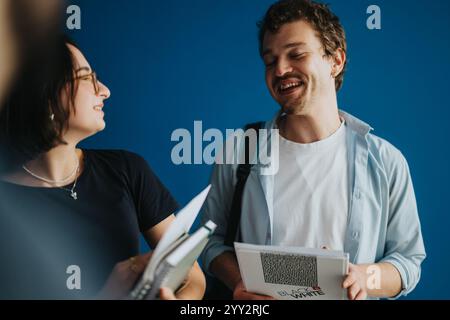 Freundliche Schüler, die zwischen den Klassen im Flur lachen Stockfoto