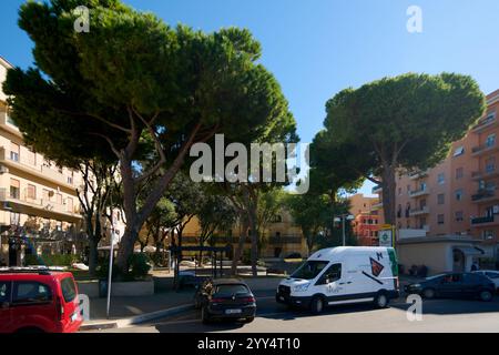 Civitavecchia, Italien - 19. Dezember 2024: Wohnplatz mit geparkten Autos, Minibus. In der Nähe befinden sich Apartments und eine Apotheke. Konzept: Nei Stockfoto