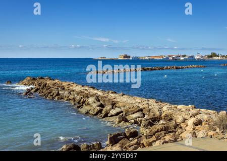 Blick vom Alykes Beach in Paphos, mit Paphos Hafen und Schloss in der Ferne, Zypern Stockfoto