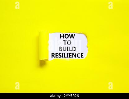 So erstellen Sie ein Resilienzsymbol. Konzeptworte wie man Resilienz auf einem schönen Whitepaper aufbauen kann. Schöner gelber Hintergrund. Unternehmen und wie man baut Stockfoto