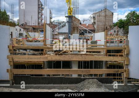 Stahlbetonuntergeschoss eines im Bau befindlichen Residentalhochhauses im neuen Stadtteil. Betongießen, Metallrahmenpfähle, Stahlstäbe Stockfoto