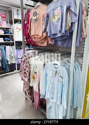 Kiew, Ukraine - 18. Dezember 2024: Eine Auswahl an niedlichen und farbenfrohen KinderPyjamas hängt an Regalen im Kleidergang eines Geschäfts. Der Schlafanzug Stockfoto