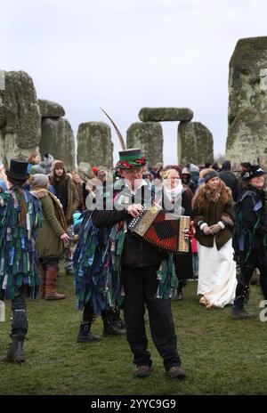 Salisbury, England, Großbritannien. Dezember 2024. Die White Horse Morris Group tritt während der Wintersonnenfeier für die Menschenmassen auf. Die Wintersonnenwende 2024 markiert sowohl den kürzesten Tag als auch die längste Nacht des Jahres. Die Sonnenwende ist auch der Beginn des historischen heidnischen Festivals Yule. Stonehenge wurde gebaut, um sich an den Sonnenzeiten an der Sonne auszurichten. (Kreditbild: © Martin Pope/ZUMA Press Wire) NUR REDAKTIONELLE VERWENDUNG! Nicht für kommerzielle ZWECKE! Quelle: ZUMA Press, Inc./Alamy Live News Stockfoto