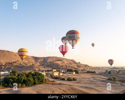 Heißluftballons fliegen über das Tal der Könige, Luxor, Ägypten vor dem Himmel und der Hügellandschaft - Landschaftsaufnahme Stockfoto