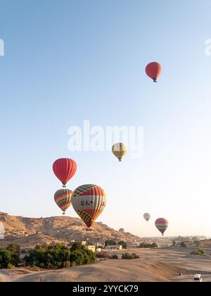 Heißluftballons fliegen über das Tal der Könige, Luxor, Ägypten vor der Kulisse des Himmels und der Hügel - Portrait Shot 2 Stockfoto