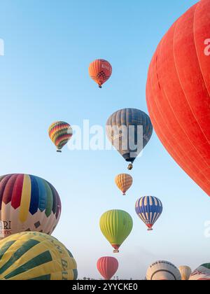 Heißluftballons fliegen über das Tal der Könige in Luxor, Ägypten vor der morgendlichen Kulisse des blauen Himmels Stockfoto