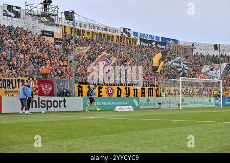 Unterhaching, Deutschland. Dezember 2024. Die Fans aus Dresden unterstuetzen ihr Team in Unterhaching/Ultras/3. Liga: SpVgg Unterhaching - Dynamo Dresden, Uhlsportpark am 21.12.2024 Credit: dpa/Alamy Live News Stockfoto