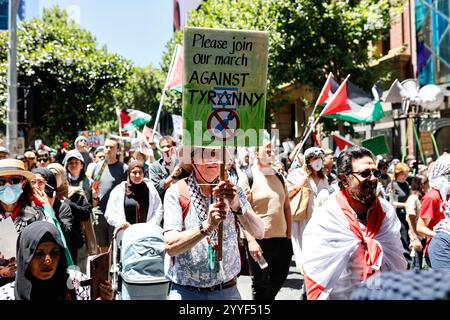 Melbourne, Australien. Dezember 2024. Ein Demonstrant hält während der Kundgebung ein Plakat. Demonstranten hielten eine Kundgebung in Melbourne CBD ab und forderten Sanktionen gegen Israel an Weihnachten, um die zionistische Aggression zu beenden und Menschenleben im Nahen Osten zu ehren. (Foto: YE Myo Khant/SOPA Images/SIPA USA) Credit: SIPA USA/Alamy Live News Stockfoto