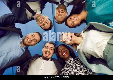 Porträt eines fröhlich lächelnden Geschäftsleuten, der im Büro in die Kamera hinunterblickt. Stockfoto