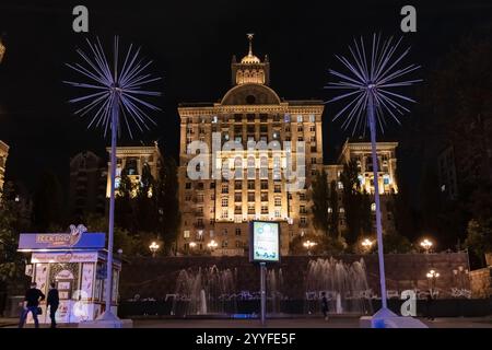 Ein großes Gebäude mit zwei hohen Lichtern darüber. Die Lichter sind blau und leuchten nachts auf Stockfoto