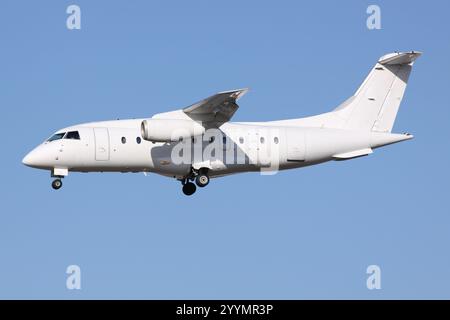 Ein kleines White Jet Flugzeug, das in hellem Abendlicht ankommt Stockfoto