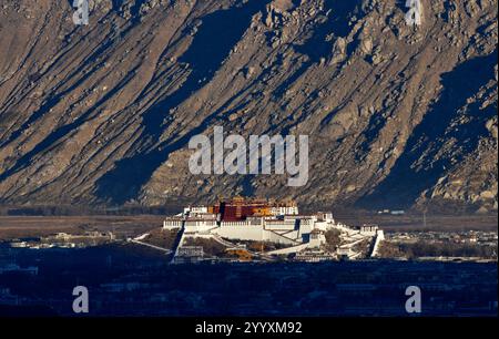 Lhasa, China. 21. Dezember 2024. Das Foto vom 21. Dezember 2024 zeigt den Sonnenaufgang auf dem Potala-Palast in Lhasa, der Hauptstadt der Autonomen Region Xizang im Südwesten Chinas. Quelle: Li Lin/China News Service/Alamy Live News Stockfoto