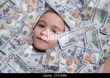 Amerikanische Träume. Kinder gehen in Geld. Lustiges Kindergesicht auf Dollargeld. Geldscheine, Bargeld-Scheine, 100 US-Dollar-Banknoten Stockfoto