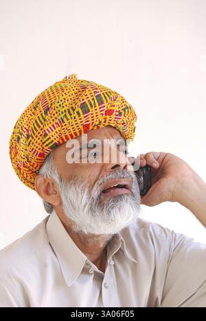 Rajasthani Mann im Turban, der auf dem Handy spricht, Jodhpur, Rajasthan, Indien MR#704 Stockfoto
