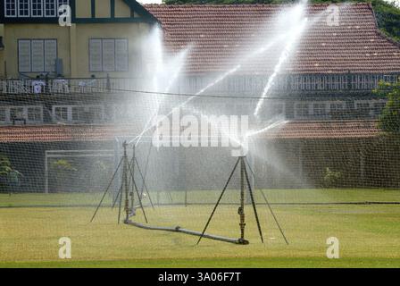 Sprinkleranlage, die Wasser für üppiges grünes Gras im Garten von Bombay Gymkhana in Azad Maidan, Bombay, sprengt Stockfoto