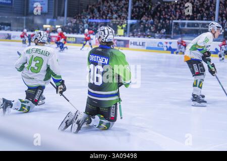 Zwei Eishockeyspieler in grünen Trikots knieten während eines Spiels vor Publikum auf dem Eis, Heilbronner Falken vs Bietigheimer Steelers, Heilbr Stockfoto