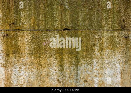 Raue Betonwand mit gelben Flecken Stockfoto