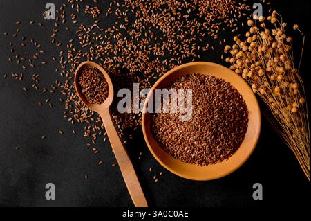 Bio-Müsli. Gesunde Ernährung. Flachssamen in einem Holzlöffel und Teller. Draufsicht Stockfoto