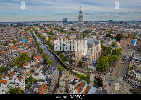 Atemberaubende Aussicht auf Westerkerk, die protestantische Kirche in Amsterdam und die ikonische Architektur, Kanäle und pulsierende Stadtlandschaft. Stockfoto