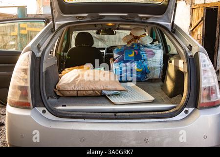 Dinge im Auto mit ausgeklappten Rücksitzen, selektiver Fokus Stockfoto