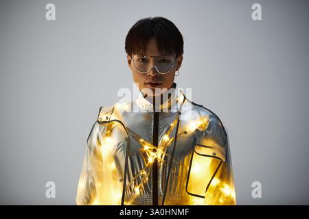 Ein eleganter junger asiatischer Mann zeigt modisches Flair und strahlt eine Aura von Selbstvertrauen und Charme aus. Stockfoto