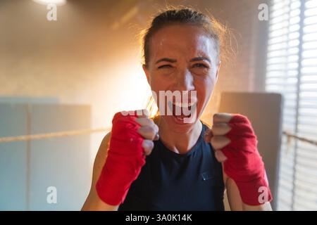 Aufschrei unabhängiger Mädels Macht. Wütende, starke, verrückte Kämpferin, die aggressiv auf Boxring aussieht. Mächtig ehrgeizig, siegreich, selbstbewusst, erfolgreich, weiblich und emotional energisch Stockfoto