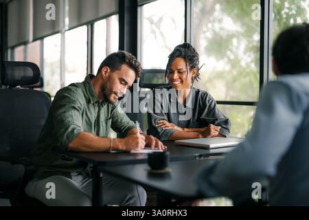 Team aus Spezialisten für Industriedesign und Softwareentwicklern, die im Büro diskutieren Stockfoto