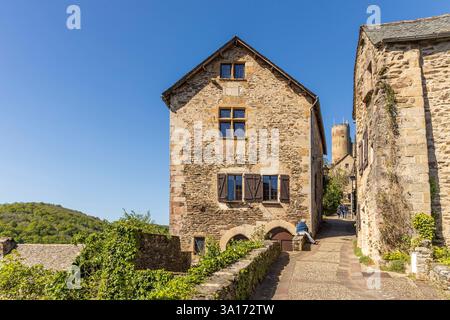 Frankreich, Aveyron, Najac, beschriftete die schönsten Dörfer Frankreichs, Straße im mittelalterlichen Dorf und die Burg von Najac, ehemalige königliche Festung im Hintergrund Stockfoto
