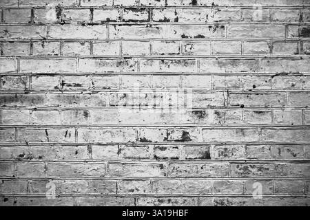 Hintergrundstruktur - Alte graue Ziegelwand mit grauen weißen schwarzen Ziegeln Stockfoto