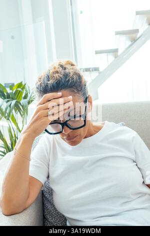 Close up unglückliche verärgerte Frau mit geschlossenen Augen, die Schläfen berühren, unter starken Spannungskopfschmerzen, chronischer Migräne, tiefem Atmen, müder junger weiblicher Schmerz, Unwohlsein und ungesund leidet Stockfoto